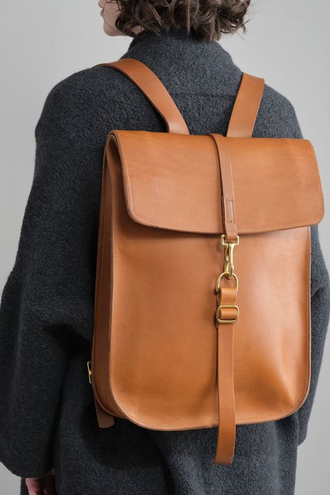 The Postal Backpack No. 1 is inspired by 19th-century US postal bags that were attached to cranes near trains, ready to be picked up by passing trains. Created from 2.2mm water-resistant Italian leather, this backpack is carefully chosen for optimal density, strength, and softness. The color of the bag will deepen with exposure to snow, rain, and sun. Over time, the leather will soften with frequent use. Hand-tooled and manufactured in limited batches, the solid brass closure is sourced from a small foundry in England. Anatomy Stickers, Snow Rain, Leather Totes, Women Leather Backpack, Leather Crafts, Product Ideas, Leather Bags Handmade, Leather Diy, Personalized Accessories