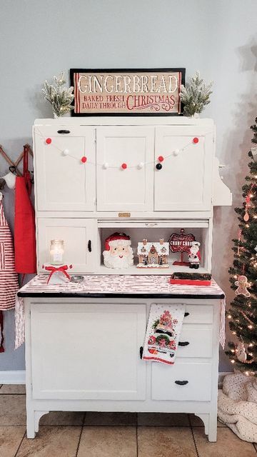 Desiree || Home & Garden on Instagram: "The Hoosier is decorated for Christmas and I am obsessed! Watch until the end for a quick peak at the kitchen Christmas tree fully decorated. I'll share that tomorrow! You guys are going to love it. #christmasinspiration #hoosiercabinet #decoratingforchristmas #christmasdecor #christmasdecorating #mymichaels #hobbylobbychristmas #gingerbread #gingerbreadhouse #christmaskitchen" How To Decorate A Hoosier Cabinet, Kitchen Christmas Tree, Remodeling House, Hoosier Cabinet, Hobby Lobby Christmas, Kitchen Christmas, Christmas Kitchen, Christmas Inspiration, Gingerbread House