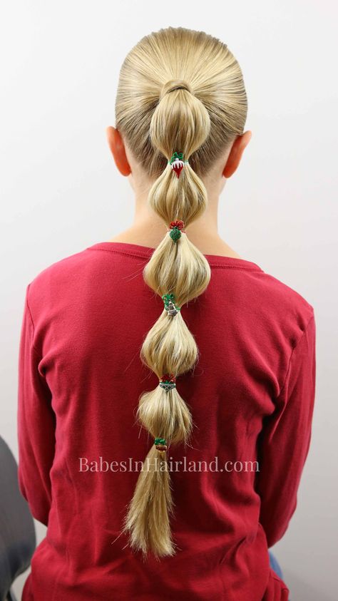 Make a fun bubble ponytail for Christmas with some cute holiday buttons. Try this cute hairstyle out for Christmas this year from BabesInHairland.com #hair #hairstyle #bubbleponytail #Christmas #Christmashairstyle #easyhairstyle #cute #ponytail Kids Bubble Braid, Hairstyles With A Ponytail, Bubble Ponytail Hairstyles, Bubble Braid Ponytail, Tree Braids Hairstyles, Bubble Christmas, Cute Ponytail, Bubble Braid, Softball Hairstyles