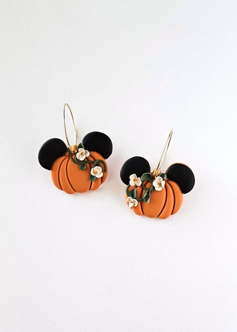 Get ready for the pumpkin season this Fall in these botanical pumpkins with adorable mouse ears. The earrings feature a vibrant orange pumpkin hue and are elegantly styled as hoop dangles with secure latch back closures. Perfect for adding a touch of whimsy to any outfit! 🎃🐭 Each item is designed and crafted by me with passion and care. As the creator, designer, and artist, I take pride in every piece I make. Please keep in mind that, while I hold myself to high standards for quality, handmade items may have slight variations and imperfections that make them one-of-a-kind. So embrace the charm and character that comes with each handmade creation! Follow @clayunico on instagram! Care: All earrings are made of polymer clay, which is a durable and water-resistant material. Maintain the long Disney Clay Earrings Diy, Pumpkin Polymer Clay Earrings, Disney Polymer Clay Earrings, Halloween Earrings Diy, Pumpkin Clay Earrings, Fall Polymer Clay Earrings, Halloween Clay Earrings, Pumpkin Clay, Thanksgiving Earrings