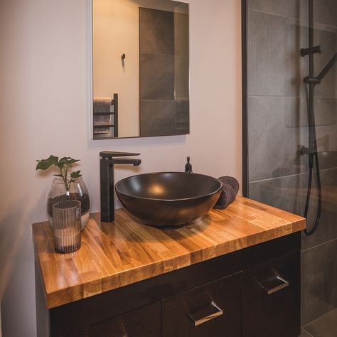 Nice bathroom vanity with black bowl on top of a varnished timber top beside a tiled shower with black fittings. A mirror is positioned above (Bathroom Renovations Christchurch). Bathroom Vanity With Black Sink, Bathroom Vanity Ideas Bowl Sink, Bathroom With Bowl Sink, Black Grey Wood Bathroom, Black Vanity Wood Top, Black Bathroom Vanity With Wood Top, Small Vanity With Bowl Sink, Diy Black Bathroom Vanity, Bathroom Sink Bowls On Top