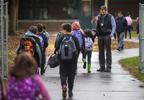 Manitou Park Elementary School, as part of a districtwide effort in Tacoma this year, has started sending “nudge” letters to parents of students missing too many classes. Principal Steven Mondragon greets students as they arrive on time one recent morning. (Mike Siegel/The Seattle Times) Letters To Parents, Absent Students, Student Attendance, School Attendance, Letter To Parents, Elementary School Students, Elementary School, First Day Of School, Elementary Schools