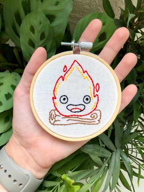 An embroidery of calcifer from howls moving castle in a hoop, available on my etsy store!✨ Calcifer Embroidery Pattern, Studio Ghibli Embroidery Simple, Calcifer Cross Stitch, Calcifer Embroidery, Howls Moving Castle Embroidery, Studio Ghibli Embroidery, Ghibli Embroidery, Totoro Cross Stitch, Calcifer Howl's Moving Castle