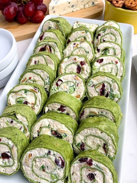 are filled with chicken, almonds, cranberries, green onions, and feta, rolled up in spinach tortillas. A great appetizer for parties -- and they taste even better than they look. As an Amazon Associate I earn from qualifying purchases. You Tortilla Pinwheel Appetizers, Chicken Cranberry Salad, Tortilla Pinwheels Recipe, Spinach Tortillas, Chicken Cranberry, St Patricks Food, Chicken Pinwheels, Cream Cheese Pinwheels, Pinwheel Sandwiches