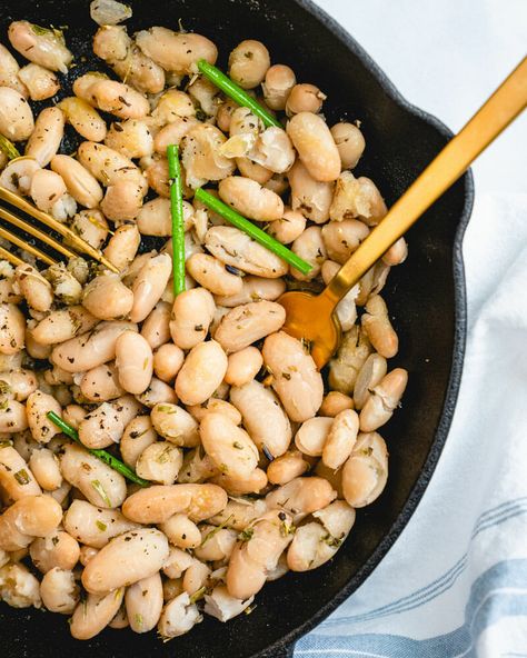 Make cannellini beans into a tasty side dish with this easy recipe! It's packed with Mediterranean flavor and plant-based protein. #cannellinibeans #cannellini #beans #beanrecipe #5minuterecipe #quickdinner #fast #easy #healthy Cannellini Beans Recipes, White Bean Recipes, Cannellini Bean, A Couple Cooks, Boston Baked Beans, Vegan Recipes Plant Based, Vegetarian Cookbook, Couple Cooking, Fast Easy Meals