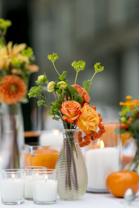 Summery orange, green, burnt orange bud vase centerpiece. Bud vases, pillar candles, votives Orange Green Wedding Decor, Orange Vase With Flowers, Orange And Green Table Decor, Orange Centerpieces For Party, Sunset Centerpieces, Orange Flower Centerpieces, Orange Table Decor, Orange Wedding Centerpieces, Orange Centerpieces