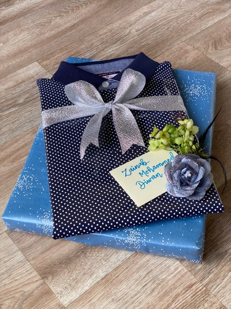 Tshirt gift wrapping Gift Wrapping Ideas For Tshirts, Tshirt Packing Ideas Gift, Tshirt Wrapping Ideas, Shirt Packing Ideas Gift Birthday, How To Wrap A Tshirt Present Gift, Tshirt Gift Wrapping Ideas, Gift Wrap Tshirt, Cotton T-shirt As Holiday Gift, Corner Wall Shelves