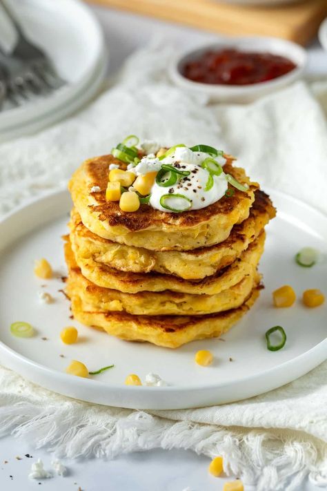 These easy corn fritters are soft in the middle with beautifully golden, crisp, buttery edges. Made from a simple batter with creamed corn, bursts of sweet corn kernels and salty feta, this recipe is a pantry-staple saviour when you need a quick and easy lunch, dinner or lunchbox snack. Creamed Corn Fritters Recipe, Corn Meat Fritters, Creamed Corn Fritters, Cream Corn Fritters, Easy Creamed Corn, Corn Fritter, Corn Fritter Recipes, Easy Corn, Baking School