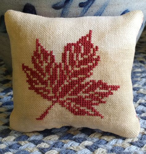 Small cross stitch autumn pillow with maple leaf. Cross Stitch Cushions, Small Leaf Cross Stitch, Cross Stitch Leaf, Cross Stitch Pillow Pattern, Cross Stitch Pillows, Fall Leaves Cross Stitch, Maple Leaf Cross Stitch Pattern, Maple Leaf Cross Stitch, Autumn Leaf Embroidery Pattern