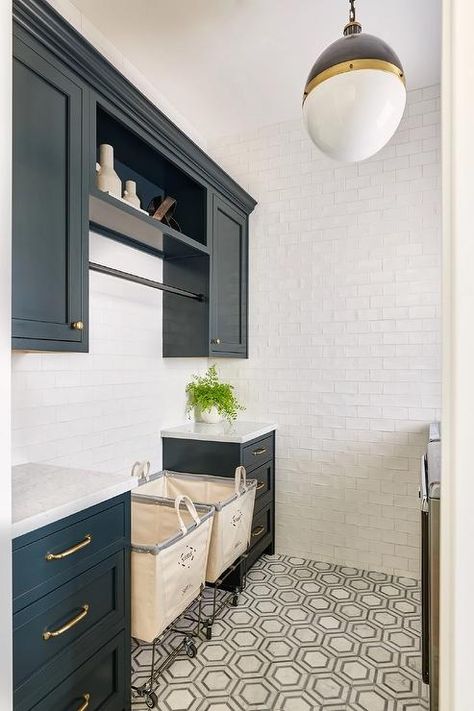 Laundry room features blue cabinets lit by a Hicks pendant, white glazed subway tiles and vintage carts on a white and gray marble hexagon tiled floor. Cottage Laundry Room, Functional Laundry Room, Transitional Laundry Room, Perfect Laundry Room, White Hexagon Tiles, Grey Laundry Rooms, Blue Laundry Rooms, Light Gray Cabinets, Laundry Powder