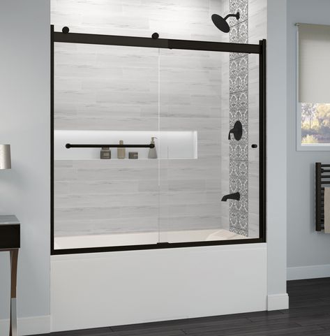 With its semi-frameless design and sleek header, the Basco Rotolo sliding tub door adds a modern touch to your shower enclosure. This door features a dual bypass rolling design and uses two rollers and an anti-jump mechanism to ensure smooth opening and closing. Crafted from ultra-durable safety-tempered glass, the two 1/4-inch thick clear glass panels beautifully showcase the interior of your shower. The reflective, lustrous finish and sleek, gently curved towel bar add to the door’s contempora Deep Bathtub Shower Combo, Modern Tub Shower Combo, Shower Tub Combo Remodel, Soaking Tub Shower Combo, Black Bathtub, Bathroom Tub Shower, Bathtub Doors, Tub Doors, Frameless Shower Doors