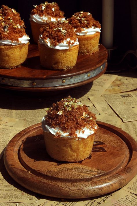 Inspired by the classic Kunafa, these delicious cupcakes are made with a kunafa crust and fluffy vanilla cake, filled with thick cream, and topped with whipped cream, crispy kunafa dough, crushed nuts, and sugar syrup. You won’t be able to stop at one! By now, everyone knows my love for Kunafa. It’s the perfect dessert ... Kunafa Cupcakes, Kunafa Dessert, Fluffy Vanilla Cake, Choux Buns, Delicious Cupcakes, Cupcake Tray, Layered Desserts, 12 Cupcakes, Sugar Syrup