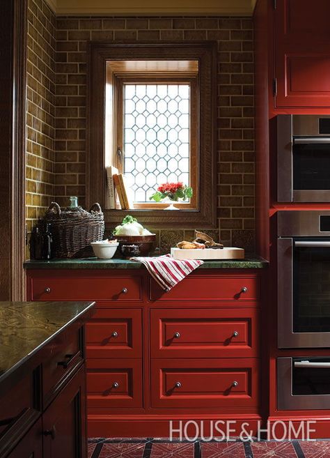 “The colors are complementary, so they work well together,” says designer Theresa Casey of this kitchen’s deep red cabinetry and dark green countertop. | Photographer: Ted Yarwood Diy Finished Basement, Moody Kitchens, Basement Remodel Ideas, Diy Finish Basement, Moody Kitchen, Marble Floors, Dark Kitchen, Small Laundry Rooms, Copper Accents