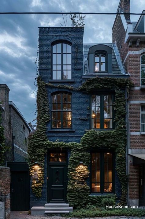 This three-story home features a deep blue exterior with a stunning ivy-covered wall. Houses With Towers, Tiny Tower, Townhouse Exterior, Apartments Exterior, Ivy Wall, Black Houses, Apartment Exterior, Paint Color Ideas, Blue Exterior