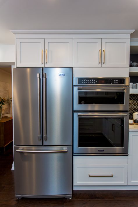 Chrome fridge and white cabinetry in the kitchen Oven Fridge Wall, Built In Oven And Microwave Next To Fridge, Double Oven Beside Refrigerator, Wall Oven And Microwave Next To Fridge, Fridge Next To Wall Oven, Wall Oven Beside Fridge, Double Oven Next To Fridge, Kitchen Built In Oven, Double Wall Oven Next To Fridge