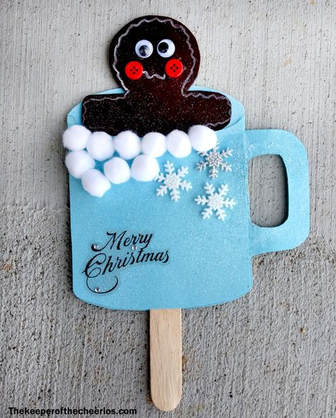 Hot Cocoa Gingerbread Man Craft Materials: Free Printable Template (Gingerbread man HERE and Cocoa Cup HERE) Brown and blue construction paper or card stock White pom poms Wiggle eyes Misc. embellishments Craft stick (popsicle stick) Scissors Glue Glitter (optional) White paint pen Red buttons Directions: Cut out of your construction paper or card stock your gingerbread man and cocoa cup Glue your cocoa cup around the outer edge of bottom piece leaving a small opening at the bottom for craft ... Gingerbread Man Craft, Crosses Crafts, Gingerbread Man Crafts, Gingerbread Activities, The Gingerbread Man, Gingerbread Crafts, Man Crafts, Christmas Crafts To Make, Christmas Activities For Kids