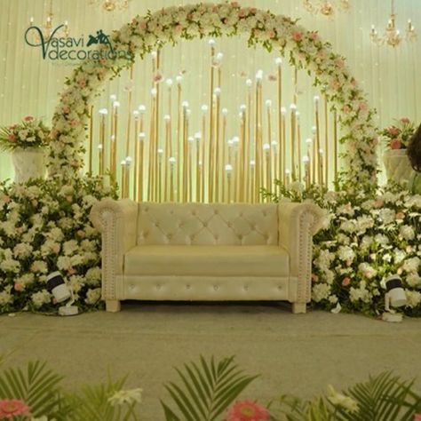 Vasavi Decorations features a captivating stage setup showcasing a plush sofa surrounded by an exquisite floral ring of elegant white flowers. The beautifully crafted arch creates a serene and sophisticated atmosphere, enhanced by soft lighting and lush greenery. This stunning arrangement is perfect for weddings, receptions, and special events, providing a timeless backdrop that elevates the overall ambiance. Celebrate your unforgettable moments with this enchanting design, where beauty and e... Weddings Receptions, Plush Sofa, Floral Ring, Lush Greenery, Soft Lighting, Be Perfect, White Flowers, Floral Rings, Special Events