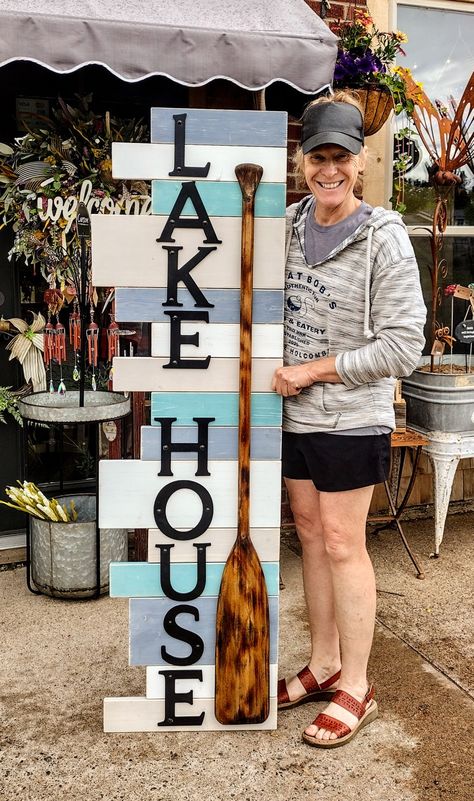 We use some scrap wood from other signs in various lengths and widths. Painted them a few different colors, took an old paddle burned it and then stained it and added some letters. Lake Themed Crafts, Lake House Crafts Diy, Lake Yard Ideas, Lake House Decorating, River House Decor, Dock Ideas, Camper Interior Design, Lake House Interior, Diy Beach Decor