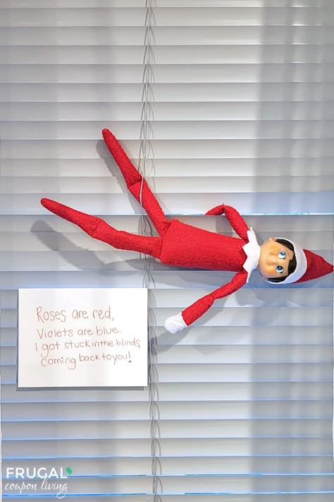 The Elf on the Shelf stuck in the blinds is a whimsical and easy-to-set-up idea that will bring a touch of enchantment to your holiday season. With just a few household items and a dash of creativity, you can create a memorable moment for your children New Elf on the Shelf ideas daily plus free Elf on the Shelf printables. #FrugalCouponLiving #ElfontheShelf Ideas To Bring Back Elf On The Shelf, How To Bring The Elf On The Shelf Back, How To Bring Back Elf On Shelf, Elf On The Shelf Back Ideas, Elf On The Shelf Printables, Elf On A Shelf, Elf Activities, The Elf On The Shelf, Door Decorations Classroom