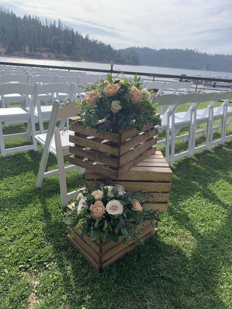 Aisle-ceremony decor using wood crates and blush tone flowers Rustic Wedding Decor Aisle, Crates With Flowers, Beginning Of Isle Wedding Decor, Wooden Crates Wedding Decor, Rustic Ceremony Aisle, Crate Wedding Decorations, Wooden Crates Wedding Ceremony, Ceremony Aisle Entrance Decor, Wedding Decor Aisle Outdoor