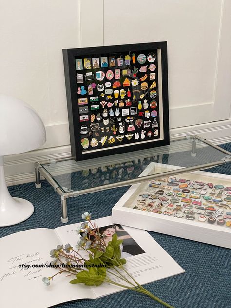 This beautiful display frame is perfect for showing off your favorite enamel pins. The glass top protects your pins from dust and scratches, and the black metal frame adds a touch of sophistication. #enamelpins #pindisplay . #Case_Board #Badge_Display #Pins_Badge_Display #Panel_Board Case Board, Enamel Pin Design, Badge Display, Pins Badge Display, Enamel Pin Display, Pin Display, Panel Board, Exhibition Display, Enamel Pin Badge