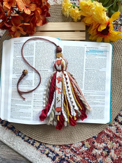 **Shipping** Shipping is 1-5 business days, although we try our best to ship ASAP! Autumn pumpkin Bible tassel! Details: * These Bible tassels hang on the side of your Bible(s). They make for a really cute and fun way to mark your place in the Bible. * The tassels have an extra long uncut cord to place in your Bible with a bead at the end to insure it fits many Bible sizes. Just simply cut the length to your liking, and then tie the bead on! Diy Bible Accessories, Bible Personalization, Diy Bible Tassels, Bible Tassel Bookmark Diy, Bible Decorating, Bible Tassel, Keychain Crafts, Bible Decor, Fall Bible Verses