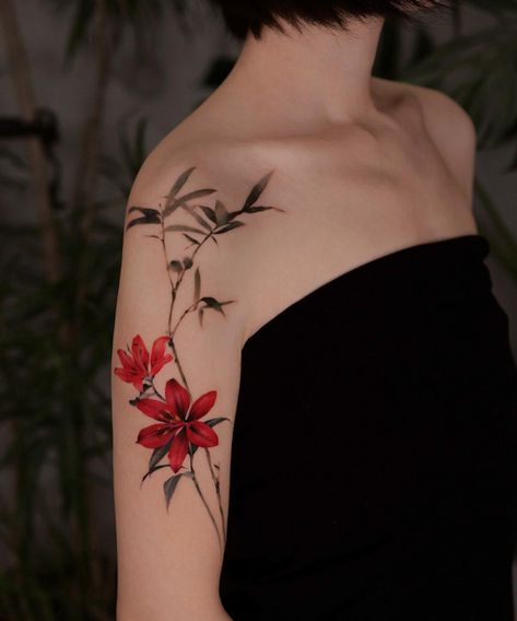 Bamboo and lily Tattoo on Upper Arm, colorful flower tattoos Red Lily Flower Tattoos, Lily Arm Wrap Tattoo, Red Lilly Flower Tattoo Designs, Red Bamboo Tattoo, Colour Lily Tattoo, Lily Tattoo Color, Tattoo On Upper Arm, Red Lily Flower, Red Lilies