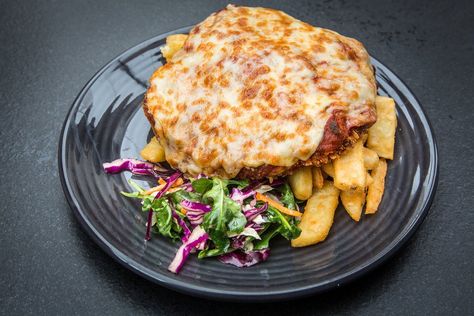 At The New Sydney Hotel in the Tasmanian capital, Hobart, the sauce on the chicken Parma is house-made, with a hint of smokiness, and the cheese is blistered perfectly. The classic Australian pub meal puts a breaded, fried chicken cutlet under a slice of ham, a layer of red sauce and melted cheese, and over a pile of fries. Australian Chicken Parma, Chicken Parma, Australian Foods, Pub Ideas, Fried Chicken Cutlets, Chicken Cutlet, Sydney Hotel, Australian Food, Embracing Change