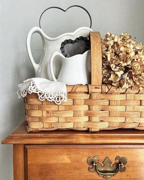 Wicker Chest Decor Ideas, Display Baskets Ideas, Baskets On Top Of Hutch, Vintage Buffet Decor, Wooden Tool Box Decor, Farmhouse Baskets Decorating Ideas, How To Decorate With Baskets, Wicker Basket Decor Ideas, Picnic Basket Decor