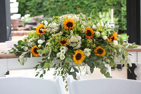 Sunflower Wedding Top Table Arrangement #wedding #tabledecoration Sunflower Wedding Top Table, Sunflower Top Table Arrangement, Sunflower Backdrop Ideas For Wedding, Modern Sunflower Decor, Sunflower Table Decorations Wedding, Wedding Table Sunflower, Sunflowers And Eucalyptus Wedding, Sunflowers And Roses Floral Arrangements, Sunflower Wedding Table Decorations