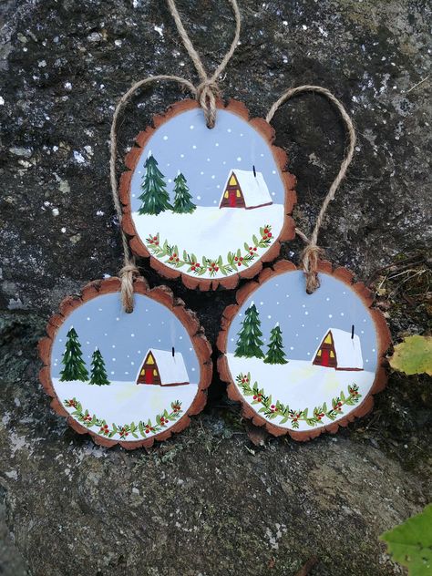 Snowy pine tree and a-frame scene wood slice ornament.  Every ornament is approximately 2 1/2 - 3 1/2 inches wide, hand painted with quality acrylic paint, sealed with a  protective finish and hung with rustic twine. Please note that all ornaments are handmade and no two paintings are exactly the same. Each wood slice may vary a bit in size and shape and with the rustic quality of the material, some of the bark may come off at some point. Sometimes a little glue will do! Two Paintings, Painted Ornament, Rustic Ornaments, Painted Christmas Ornaments, A Frame Cabin, Wood Slice Ornament, Wood Christmas Ornaments, Wooden Christmas Ornaments, Wooden Ornament