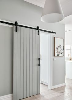 Unlike a standard hinged door that requires floor space to swing open, a sliding barn door takes up little more space than the thickness of the door. #hallway #slidingdoor #barndoor #realhomes Small Hallway Ideas, Diy Barn Door Hardware, Diy Sliding Barn Door, Sliding Door Design, Barn Door Kit, Modern Barn Door, Hallway Designs, Hal Decor, Hallway Ideas Entrance Interior Design