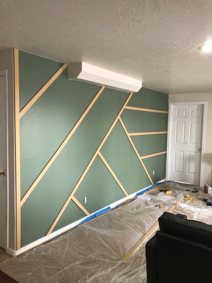 I was asked to help a friend makeover her basement, so we planned and I came up with this. This is where we started, she told me she wanted a modern industrial touch and she loved the geometric accent wall I did for my daughters bedroom 👇 So I went to work by drawing up a few different designs for her wall.once I was happy with the design I went to the hardware store and purchased a sheet of 1/2 mdf boardliquid nailand some nailsand I grabbed some primer and paintOnce I got h… Wood Accent Wall Pattern Ideas, Modern Bedroom Paint Colors Accent Wall, Bedroom Wall Geometric Designs, Accent Wall Bedroom Geometric, How To Make A Geometric Accent Wall, Accent Wall Colors Office, Geometric Wood Wall Design, White Slat Wall Bedroom, Accent Wall With Design