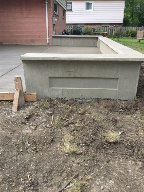 Concrete patio retaining wall created by Nitti Cement, IL Concrete Half Wall Outdoor, Concrete Patio Retaining Wall, Stamped Concrete Retaining Wall, Wall Backyard Ideas, Poured Concrete Retaining Wall, Front Porch Sitting Area, Patio Retaining Wall, Yard Renovation, Poured Concrete Patio