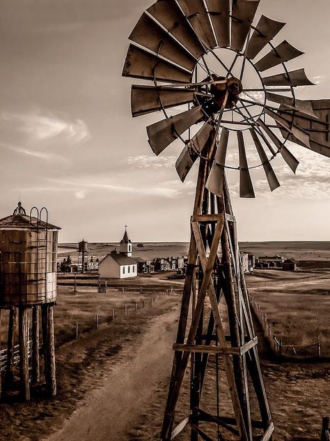 An old windmill standing as a sentinel over the old town on the western frontier. Description from finearta… | Western photography, Old western towns, Western photo Western Aesthetic Wallpaper, Old Western Towns, Old West Town, Country Backgrounds, Western Photo, Old Windmills, Western Artwork, Cowboy Aesthetic, Western Photography