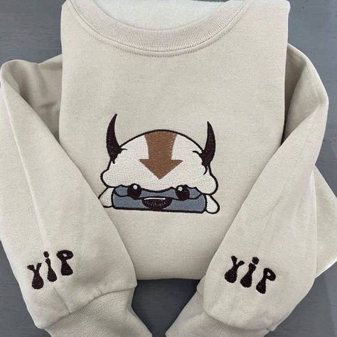 Appa Avatar Embroidered Sweatshirt Bison Custom Design Sweatshirt Yip Yip Appa Sweatshirt Appa Avatar Embroidered Sweatshirt Bison Custom Design Sweatshirt Yip Yip Appa Sweatshirt is best Embroidery Clothing for you or gift for friend, family. Shopping more hoodie at here , . Appa Avatar Embroidered Sweatshirt Bison Custom Design Sweatshirt Yip Yip Appa Sweatshirt is a unique piece of clothing that will make you stand out from the crowd. It is designed with intricate detail and precision, us... Appa Sweatshirt, Appa Hoodie, Appa Embroidery, Appa Avatar, Custom Embroidered Sweatshirt, Patron Vintage, Yip Yip, Oversized Crewneck, Embroidery Sweatshirt