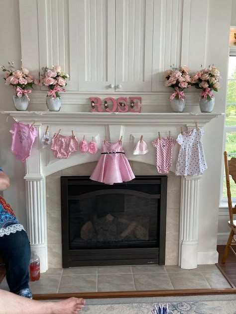 Baby Shower for Baby Rose. Mantle Decorations. Clothes garland were gifts from the hostess. Baby Shower Fireplace Mantle, Baby Clothes Baby Shower Decor, Baby Shower Staircase Decor, Onsie Garland Decoration, Fireplace Baby Shower Decor, Baby Clothes Garland, Baby Shower Fireplace Decor, Clothesline Baby Shower Decor, Baby Shower Mantle Decor