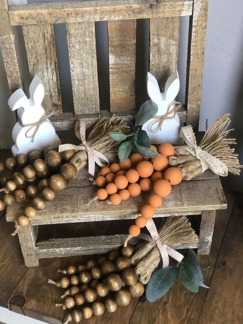 Spring Wood Bead Garland, Wood And Beads Crafts, Tiered Tray Decor Easter, Fall Kitchen Decor Farmhouse, Wood Bead Carrots Diy, Industrial Spring Decor, Decorating With Beads Garland, Spring Handmade Decorations, Easter Wooden Decor