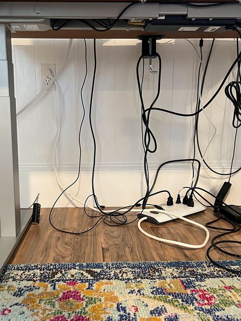 How To Hide Cords On A Standing Desk – A Pretty Happy Home How To Hide Cords On Front Facing Desk, Office Cords Hide, Hiding Cords On Desk In Middle Of Room, Hide Desk Cord, Hiding Office Cords, Hiding Monitor Cords Computer Desks, Under Desk Wire Organization, Cable Management For Standing Desk, Cover Front Of Desk