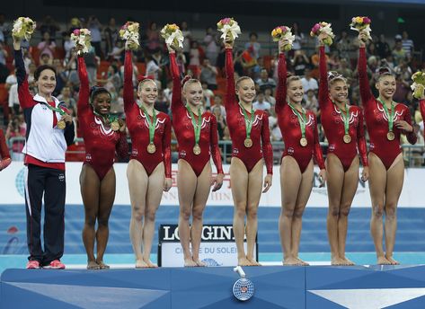 Gold medalist gymnasts of the United States raise flowers to celebrate on the podium after the awards ceremony of the women's team final of the Artistic Gymnastics World Championship at the Guangxi Gymnasium in Nanning, capital of southwest China's Guangxi Zhuang Autonomous Region Wednesday, Oct. 8, 2014. Left to right: Simone Biles, MkKayla Skinner, Alyssa Baumann, Madison Kocian Madison Kocian, Gymnastics World, Nanning, Gymnastics Photos, Gymnastics Team, Artistic Gymnastics, Simone Biles, Pin Image, Gymnastics Leotards