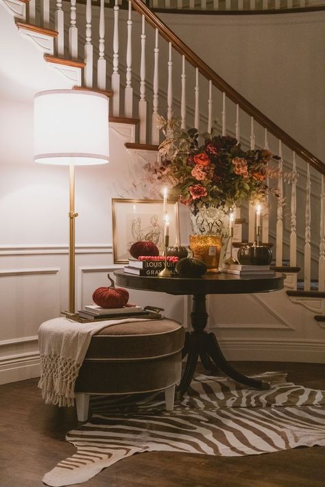 A palette of soft pinks, greys and charcoals dresses Westover’s welcoming foyer. A zebra patterned throw rug adds an extra layer of texture to the display, while an autumnal flower arrangement anchors the room Design and photo by Rebekah Westover Cozy Layered Living Room, Alice Lane Entryway, Entryway Traditional Decor, Alice Lane Living Room, Soulful Living Room, Contemporary Fall Decor, Contemporary Living Room Inspiration, Vintage Entryway Ideas, Alice Lane Interiors