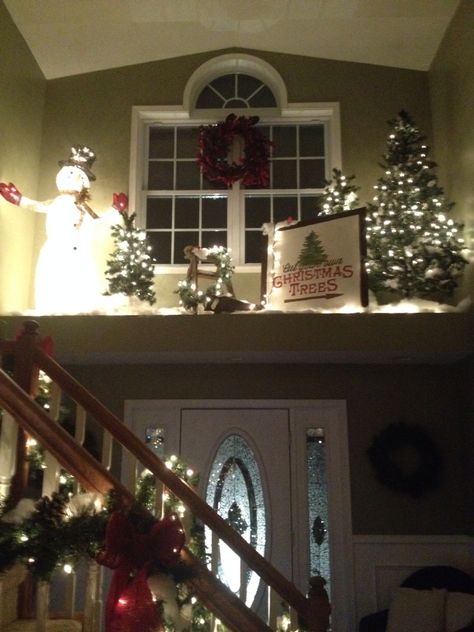 Christmas plant ledge Plant Ledges Living Room, Large Window Ledge Decor, Plant Ledge Christmas Decorating, High Shelf Christmas Decorating, Alcove Christmas Decor, Above Door Christmas Decor, Foyer Ledge Decorating Ideas Christmas, Ledge Above Front Door Decorating, Christmas Ledge Decorating Ideas