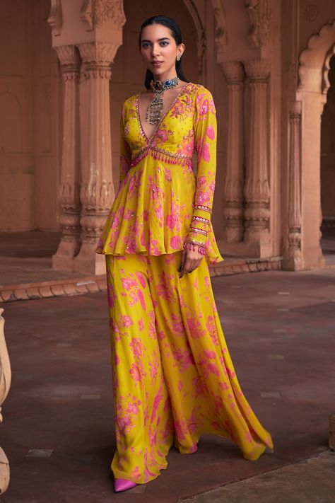 Shop for these amazing collections of Yellow Georgette Printed Floral Deep V Neck Peplum Top And Sharara Set For Women by DiyaRajvvir online at Aza Fashions. Georgette Sharara Suits, Ethnic Tops For Jeans, Floral Sharara Suit, Floral Print Dress Indian, Ring Ceremony Dress Indian, Haldi Outfits For Bridesmaid, Haldi Outfit Bridesmaid, Pink And Yellow Outfit, Top And Sharara Set