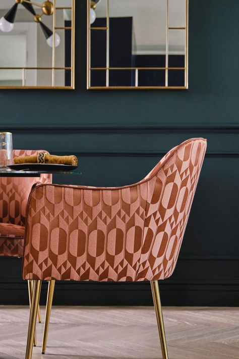 A pink 70s inspired geometric fabric with ovals and triangles upholstered on a dining room chair in a dining room setting with navy blue accent walls Contemporary Dining Room, Contemporary Dining, 70s Inspired, Modern Fabric, Elle Decor, Design Awards, Home Collections, Color Show, Wall Coverings