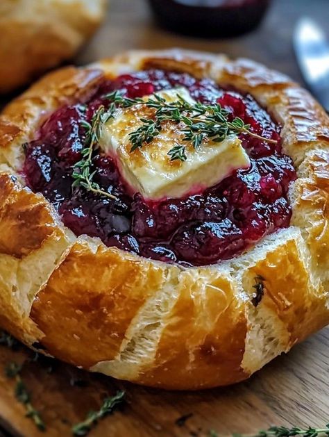 🧀 Baked Brie in Bread Bowl with Cranberry Sauce and Thyme  Ingredients:  Round loaf of bread (like sourdough) Brie cheese wheel Cranberry sauce Fresh thyme Olive oil  Instructions:  Preheat oven to 350°F (175°C). Hollow out the center of the bread loaf and place the Brie inside. Spread cranberry sauce over the top, sprinkle thyme, and drizzle olive oil. Bake until Brie is melted and gooey. Serve warm with bread chunks or crackers.  Prep Time: 10 mins | Total Time: 25 mins | Servings: 6 ￼ Baked Brie In Bread Bowl, Baked Brie In Bread, Bread Bowl Dip, Brie Recipes Appetizers, Brie Cranberry, Cheese Wheel, Brie Recipes, No Cook Appetizers, Cranberry Sauce Recipe