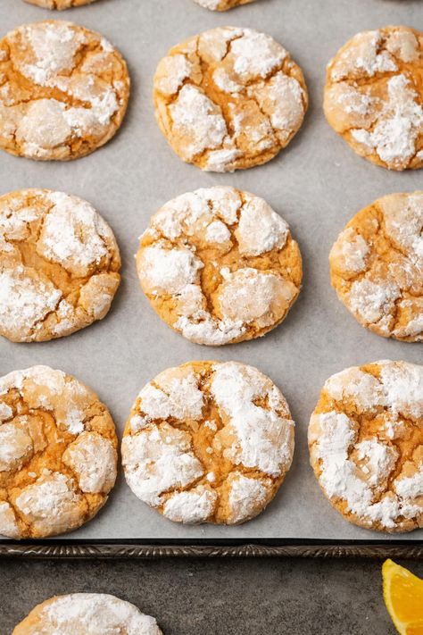 Orange crinkle cookies are soft, chewy orange cookies made with real citrus, ready in 20 minutes. Roll the dough in powdered sugar and bake! Orange Slice Cookies Recipes, Old Fashioned Orange Cookies, Chocolate Orange Crinkle Cookies, Creamsicle Orange Cookies, Orange Zest Cookies, Orange Crinkle Cookies, Orange Zest Sugar Cookies, Cracked Cookies, Orange Yogurt