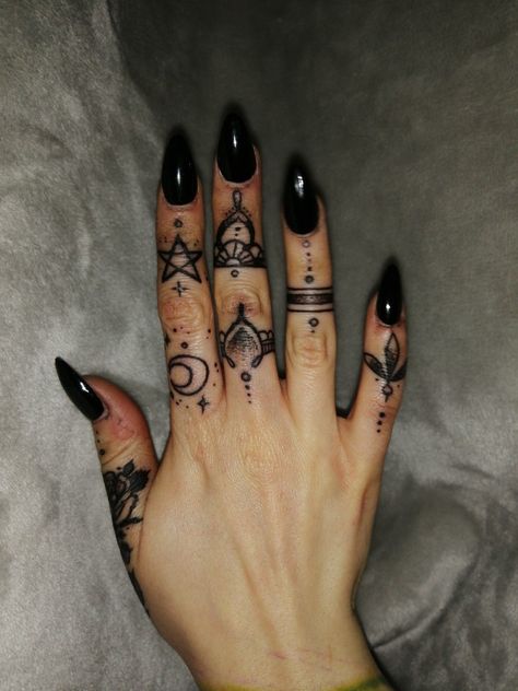 In a society captivated by grandiose ink masterpieces, small hand tattoos serve as a subtle yet impactful way to express your individuality. Goth Finger Tattoo Ideas, Hand Tattoos For Witches, Alternative Finger Tattoos, Black Out Finger Tattoo, Goth Hand Tattoos For Women, Witchy Finger Tats, Dark Finger Tattoos, Witch Finger Tattoos, Spooky Finger Tattoos