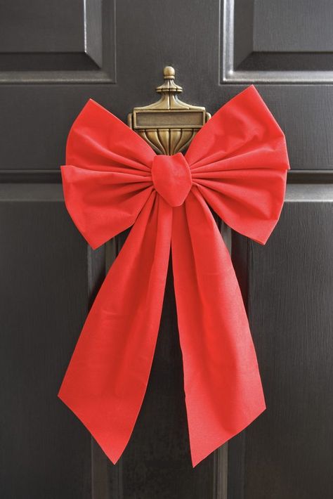 A big bow makes your door festive and welcoming. How To Make Christmas Tree Ribbon, Front Door Christmas Bows, Door Bows Christmas, Christmas Door Bow, Diy Christmas Door, Christmas Bows Diy, Door Bow, 달력 디자인, Outside Christmas Decorations