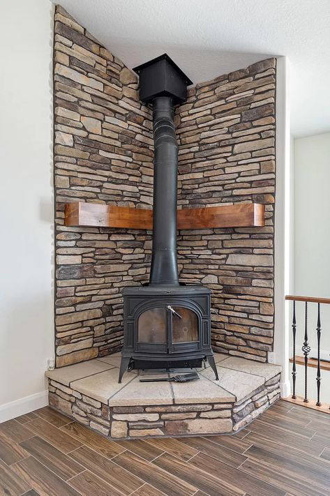 Pellet Stove Inside Fireplace, Corner Fireplace Stove Ideas, Farmhouse Living Room With Wood Stove, Wood Stove Corner Ideas Living Room, Corner Free Standing Fireplace Ideas, Woodstove Surrounds Stone, Wood Burning Stoves Living Room Corner, Wood Stove Backsplash, Corner Wood Burning Stove Ideas