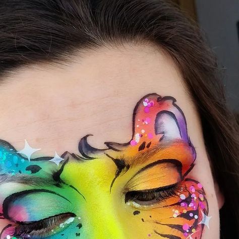 Simona Rad on Instagram: "Tiger design inspired by @_irinalizunova_ 🩷 she had a class on bright rainbow designs during the 5th Summit by @facepaintingschool 😍😍 I loved practicing along! Made the design even better using one of my favourite @oohstencils stencils - the sparkle one and the best ever glitter and my all time favourite - @essentialglitterbalm - no smudge, no glue needed, can be applied directly over the paint and it comes in sooo many colour combinations!" Rainbow Tiger Face Paint, Cheeta Face Paint, Animal Ideas, Tiger Design, Bright Rainbow, Rainbow Design, Colour Combinations, A Class, Animal Paintings